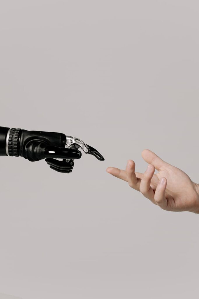 hand of a person and a bionic hand